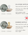 The FRIGG Rope Silicone Pacifier 2-Pack by FRIGG features grey and beige medical grade silicone pacifiers for 0-6 and 6-18 months. Both are BPA, PVC, and phthalate free, ensuring safety for your baby.