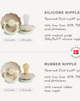 The FRIGG Daisy Night Silicone Pacifier 2-Pack by FRIGG features BPA-free pacifiers, including options for ages 0-6 and 6-18 months, with a Made in Denmark badge—ideal choices for your baby.