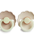 Two Frigg Daisy Night Croissant and Cream Rubber pacifiers on a white background