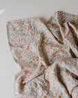 Lifestyle image of Organic Cotton Swaddle in Pastel Blooms