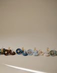 FRIGG Little Viking Silicone 2-Pack pacifiers by FRIGG, made in Denmark, are displayed in green, brown, blue, beige, and white against a neutral background.