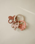 Three pastel mushie Fairy Teething Rings—food-grade silicone for sensory exploration.