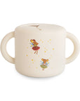 The mushie Snack Cup in Fairy Mice color is spill-proof, features two handles, and is decorated with mice in skirts and fairy wings surrounded by yellow stars.
