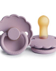 The FRIGG Daisy Natural Rubber Pacifier 2-Pack in Heather features two limited edition pacifiers: one shown front-facing with its scalloped edge, and one on its side revealing the natural rubber latex nipple.