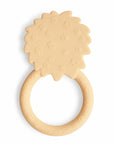 The mushie Lion Teether is a beige, non-toxic silicone baby teether with a textured surface and circular handle, shaped like a lion—perfect for soothing little gums.