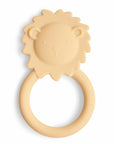 The mushie Lion Teether is a beige, non-toxic silicone teether shaped like a lion's face with a round handle. Its simple, cute design features a mane, eyes, nose, and mouth—perfect for little ones who love lion teethers.