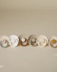 FRIGG Daisy Natural Rubber Pacifier 2-Pack, pastel colors, scalloped edges, latex nipple.
