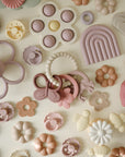 a Mushie Fairy Teething Ring that has silicone and is a baby toy for sensory exploration.