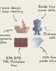 The mushie Pirate Mold Free Bath Play Set includes four non-toxic silicone shapes—a ship, bear, treasure chest, and diamond—for easy-to-clean, mold-free bath toys that inspire imaginative play and help develop motor skills.