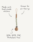 The mushie Silicone Pacifier Clip | Eva features wooden and food-grade silicone beads. Great for on-the-go, it's BPA, BPS, PVC & Phthalate free—the perfect pacifier accessory for your little one.