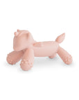 The mushie Unicorn Figurine Teether is a pale pink, silicone baby teether shaped like a cartoon unicorn with four legs, a small tail, and textured bumps on its feet—perfect for soothing little gums.