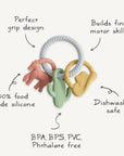 The mushie Western Teething Ring comes in three colorful silicone shapes on a white textured ring.