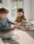 kids playing with sticker book on table
