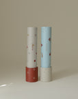 Two mushie Kaleidoscopes with playful patterns stand upright, inviting creative exploration.