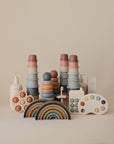 The mushie Stacking Rings Toy, made of non-toxic pastel silicone, is displayed on a neutral background.