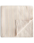 The mushie Organic Cotton Muslin Swaddle Blanket in Retro Stripes is shown folded against a white background, with one corner turned up to display the reverse side.