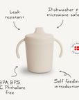 The Mushie Trainer Sippy Cup features easy-grip handles and a leak-resistant, non-toxic design. BPA, BPS, PVC & Phthalate free; dishwasher and microwave safe—ideal for self-feeding. 100% Made in Denmark badge included.