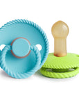 The Mushie FRIGG Rope Natural Rubber Pacifier 2-Pack features blue and green pacifiers with rope-like textured edges and natural rubber latex nipples—essential baby items.