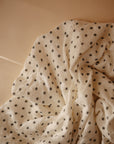 Lifestyle image of Organic Cotton Swaddle in Black Daisy