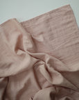 Lifestyle image of Organic Cotton Swaddle in Blush