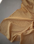 Lifestyle image of Organic Cotton Swaddle in Fall Yellow