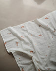 Lifestyle image of Organic Cotton Swaddle in Flowers