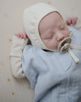 Lifestyle picture of a Mushie Sleep Bag in Baby Blue on a baby.