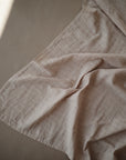 Lifestyle image of Organic Cotton Swaddle in Caramel Polka Dot