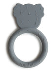 The mushie Koala Teether is a gray silicone baby teether shaped like a koala’s head on a circular ring. Textured for soothing gums, it’s non-toxic and features "mushie" embossed at the bottom.