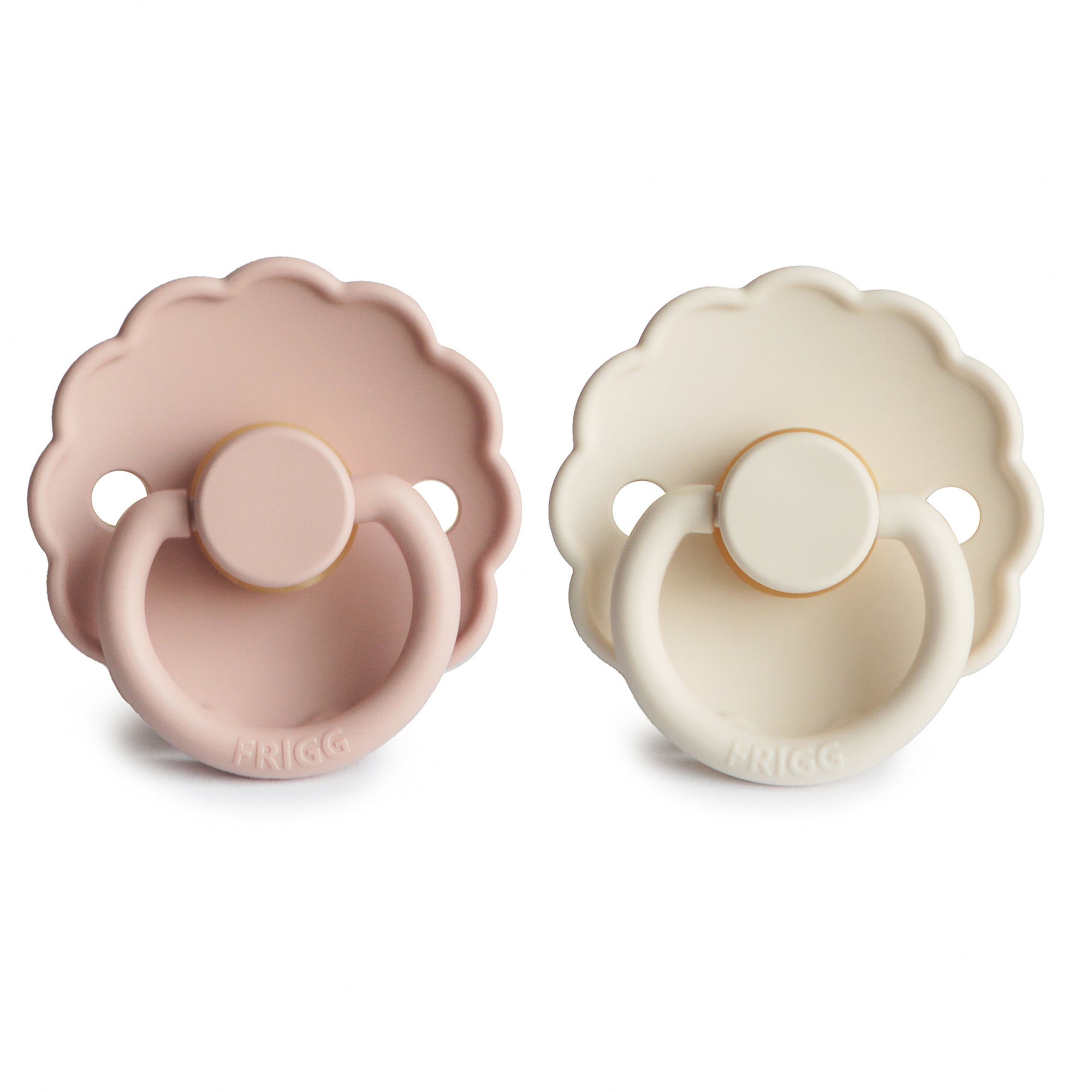Two Frigg Daisy Rubber baby pacifiers, one Blush and one Cream, on a white background