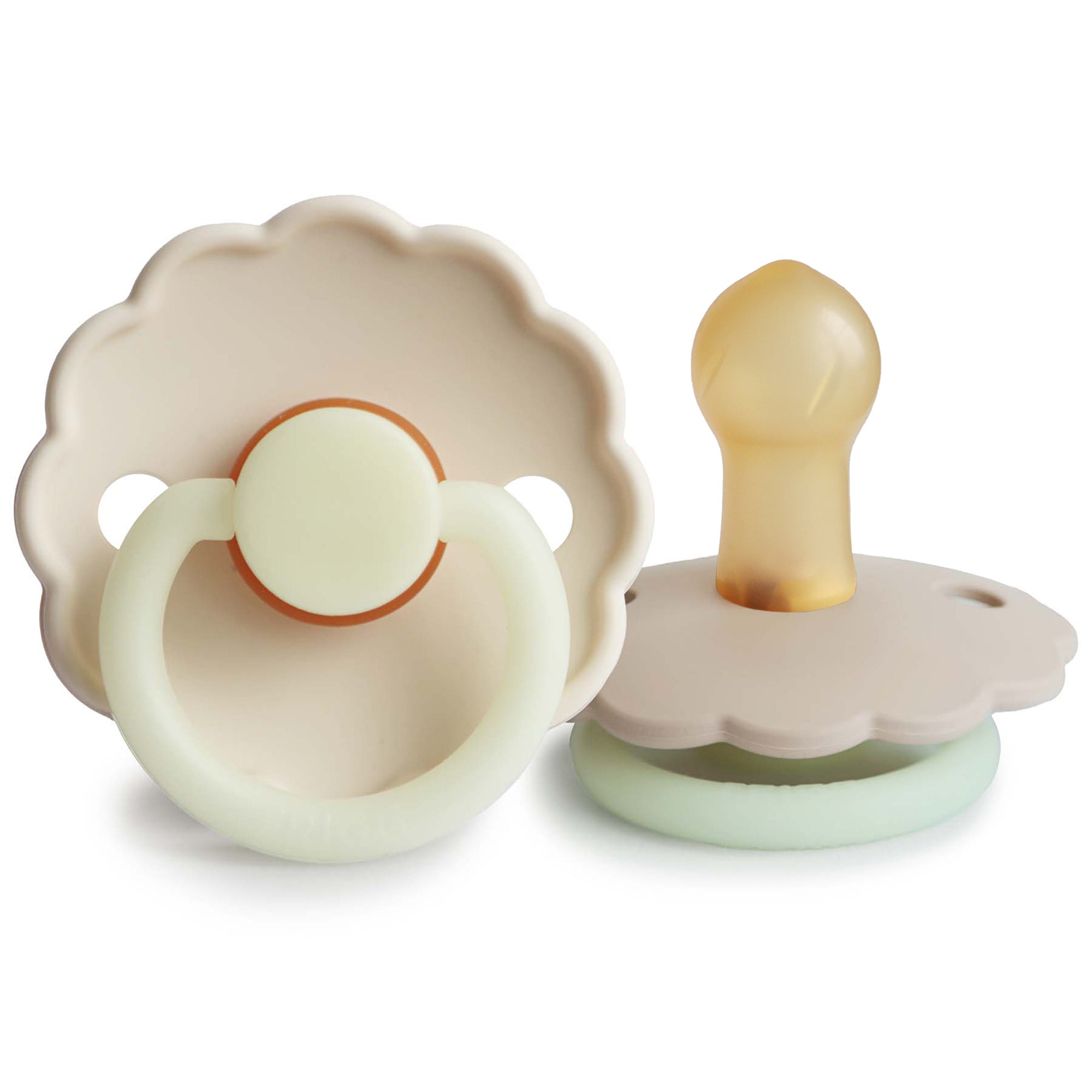 Two Frigg Daisy Night Rubber baby pacifiers in Cream and Croissant on a white background
