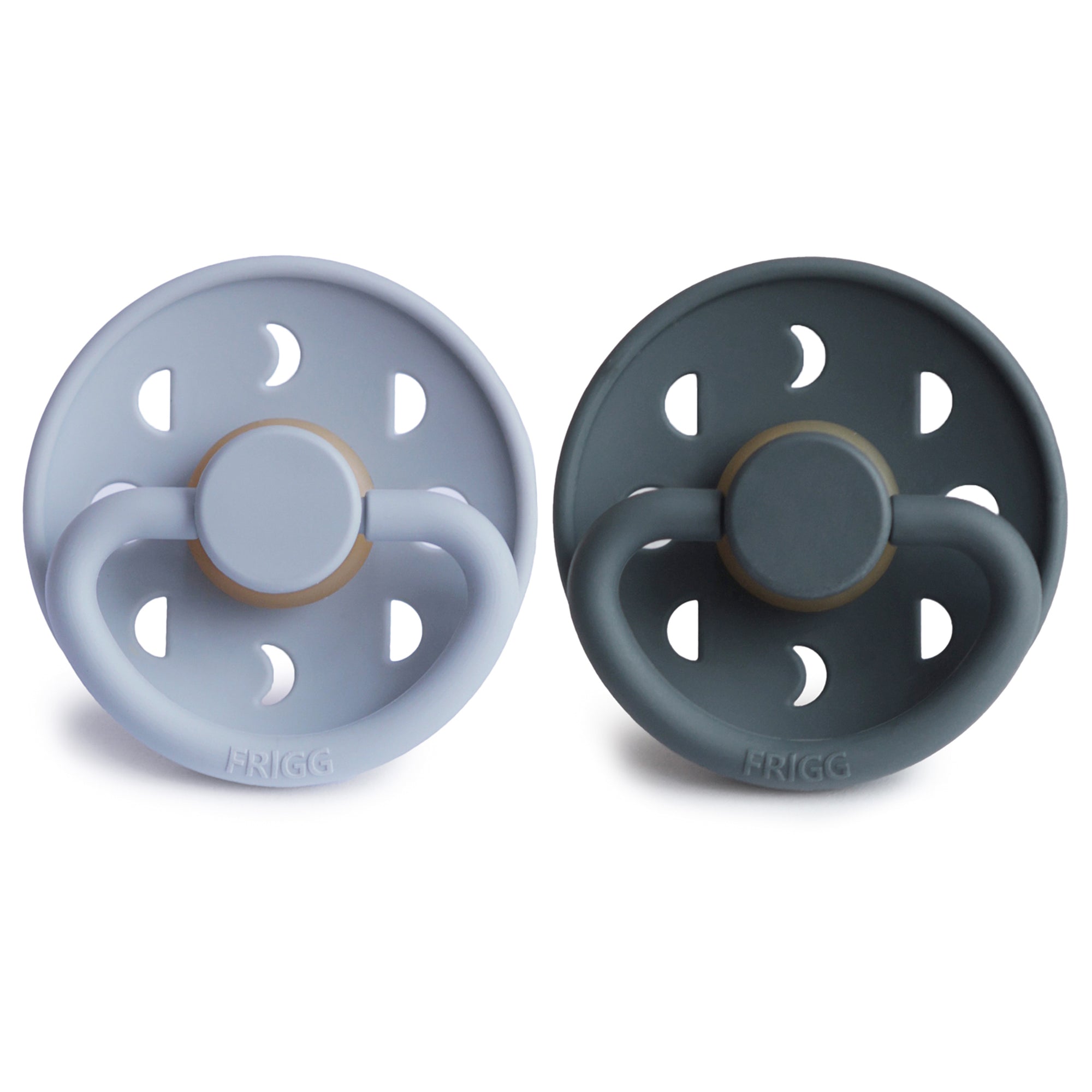 Two Frigg Moon Rubber baby pacifiers, one Powder Blue and one Slate, on a white background.
