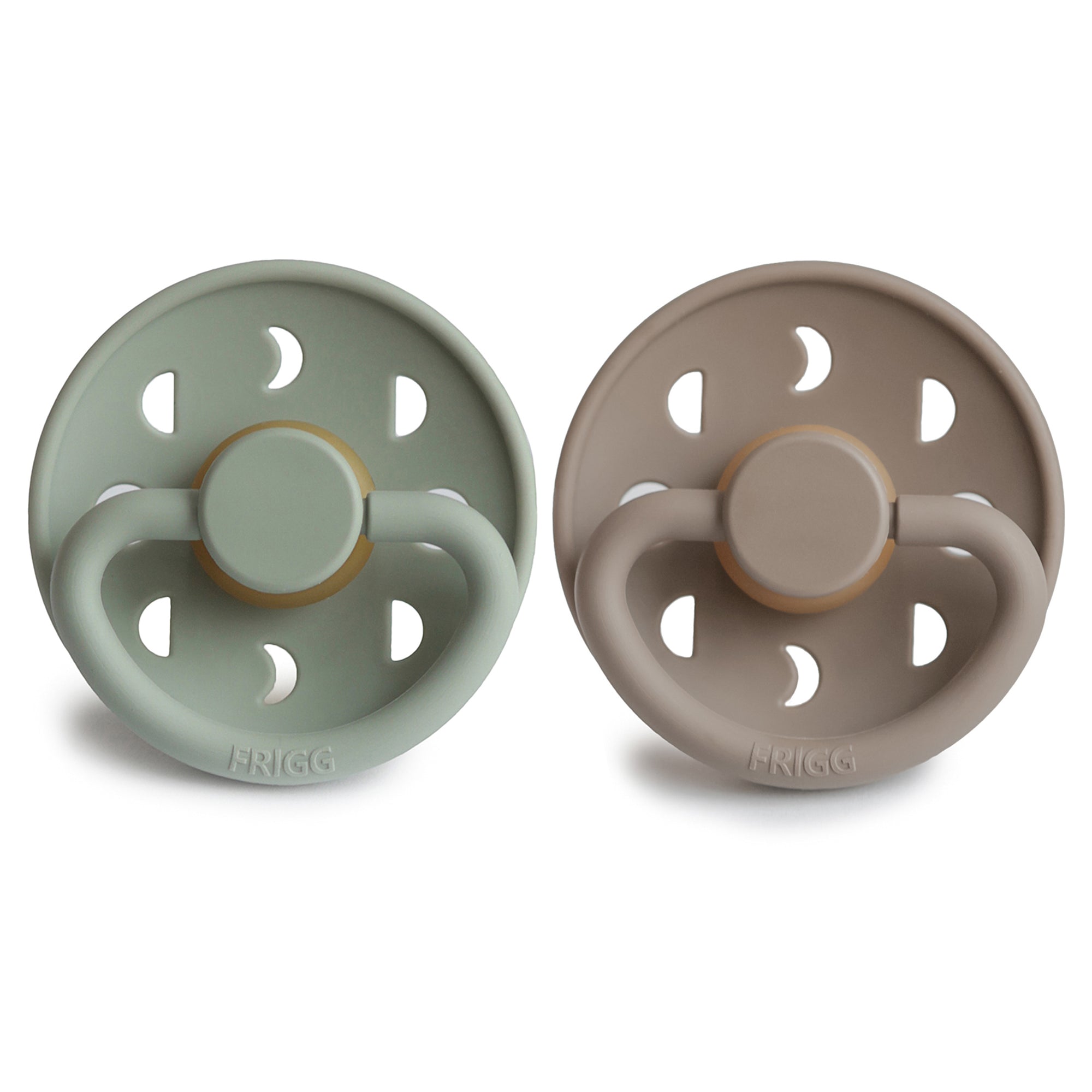 Two Frigg Moon Rubber baby pacifiers, one Sage and one Portobello, on a white background.