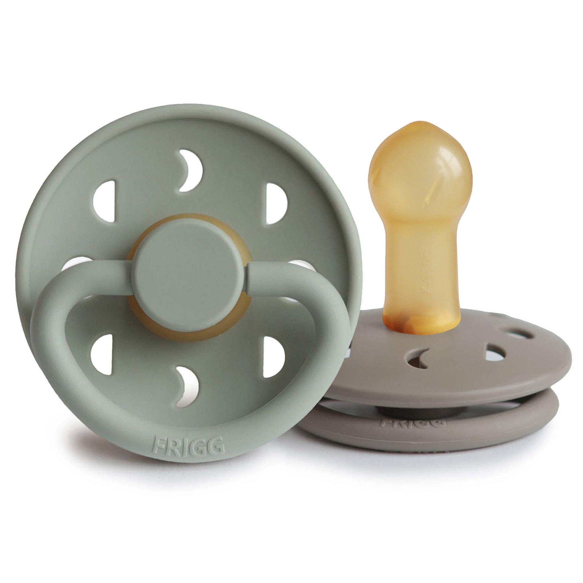 Two Frigg Moon Rubber baby pacifiers, one Sage and one Portobello, on a white background.