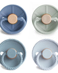 Skyline Serenity baby pacifiers in different colors on a white background