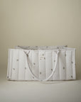 Mushie Diaper Caddy: white, quilted with small embroidery, displayed on a neutral background.