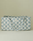 Mushie Diaper Caddy—light blue & white checkered tote bag with handles on plain background.