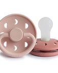 Two FRIGG Moon Silicone Pacifiers—pink 2-pack, baby essentials; one upright, one flat.