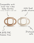 Two mushie Silicone Bottle Handles, one tan and one white, are shown. They are universal handles compatible with 4oz and 8oz bottles, made from food-grade silicone, BPA free, and dishwasher safe.
