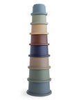 Eight colorful mushie Stacking Cups Toy inspired by Danish Hygge, perfect for stacking fun.