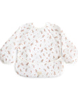 Mushie Long Sleeve Bib: white, water-resistant, floral print, pocketed baby bib.