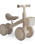 Mushie Mini Toddler Bike in Shifting Sand with front basket and cushioned seat for toddlers.