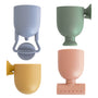 The mushie Pour and Play Bath Set features four textured, colorful cups for sensory play.
