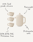 The Mushie Silicone Tea Play Set features a cream-colored pot with removable lid and three cups. Made from 100% food grade silicone, it’s dishwasher safe and free of BPA, BPS, PVC, and phthalates—perfect for pretend play!.