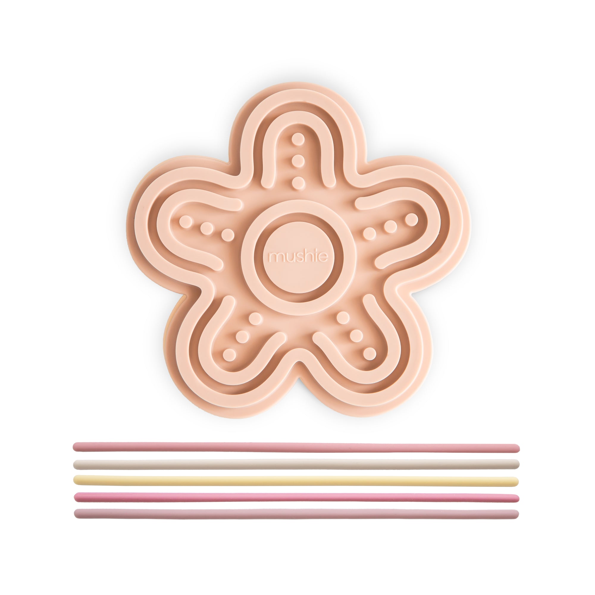 The mushie Silicone Sensory Toy is a peach flower mat with pastel straws for fine motor play.