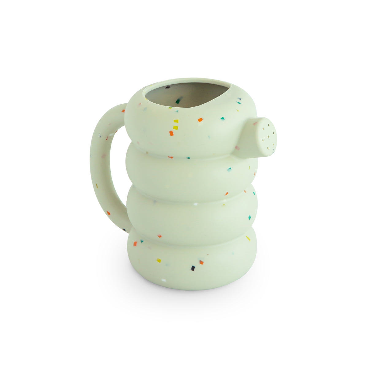 Mushie silicone watering can in light green with a tiered body and colorful confetti speckles.