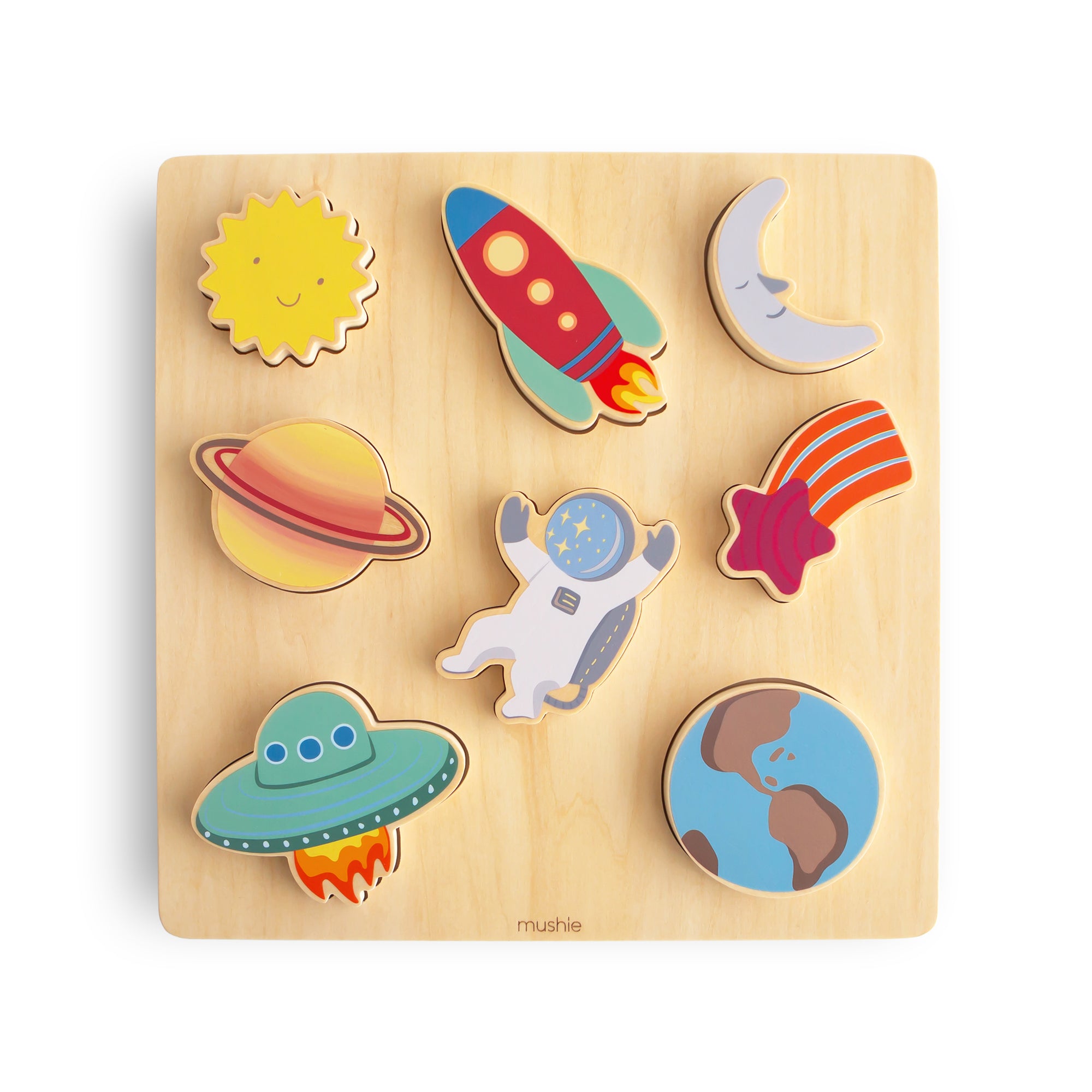 A wooden puzzle featuring colorful pieces shaped like the sun, rocket, moon, Saturn, shooting star, UFO, astronaut, and Earth, arranged on a light wood square board.