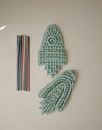 Two mushie Silicone Sensory Toys beside multicolored silicone straws for fine motor play.