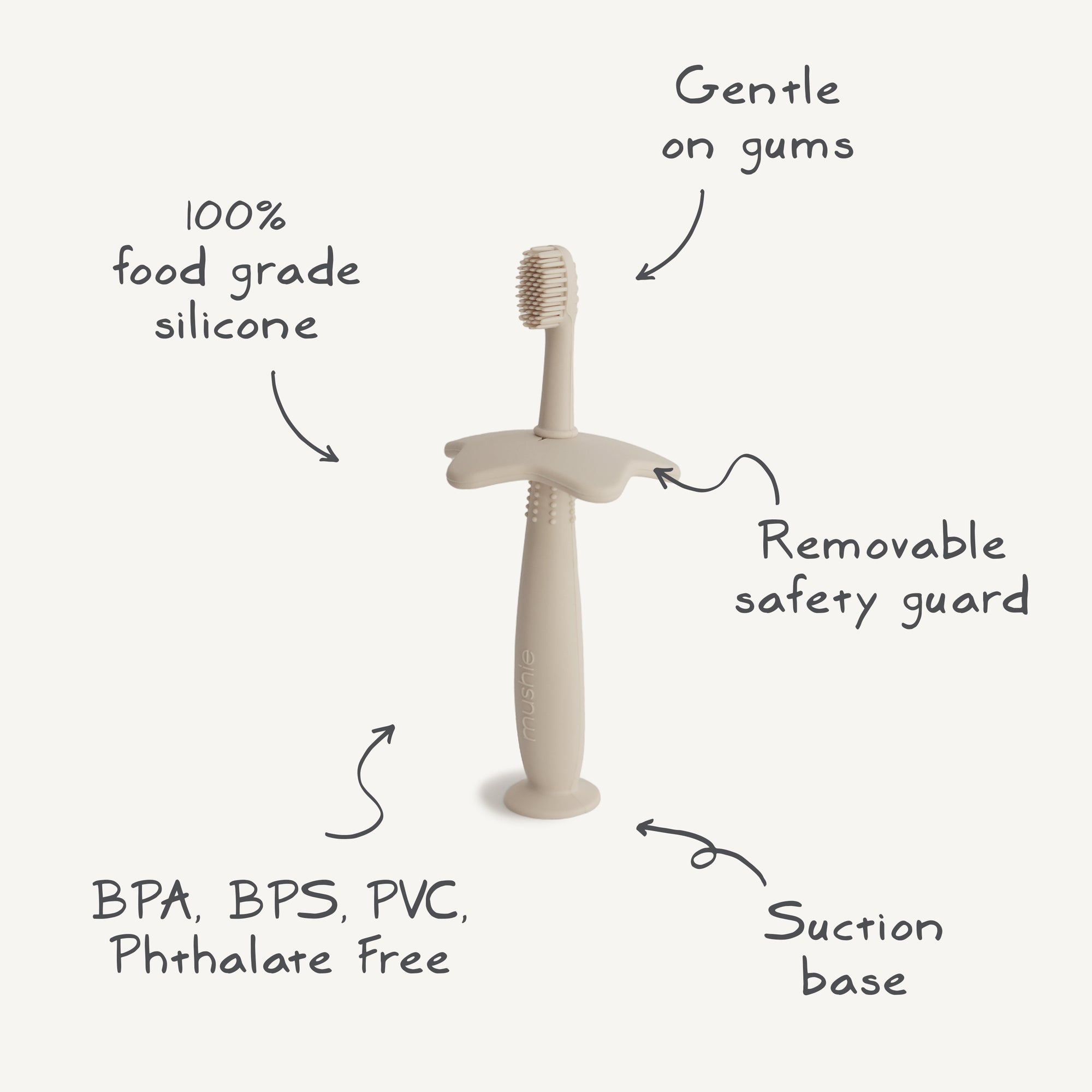 The mushie Star Training Toothbrush in beige features a removable safety guard and suction base. Made from 100% food-grade silicone, it's gentle on gums and free from BPA, BPS, PVC, and phthalates.
